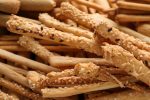 Delicious grissini sticks as background, closeup view